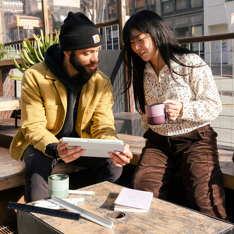 12oz-rise-mug-m7 12oz_rise_coffee_mug_dusty_orchid_couple_city_patio_square.jpg