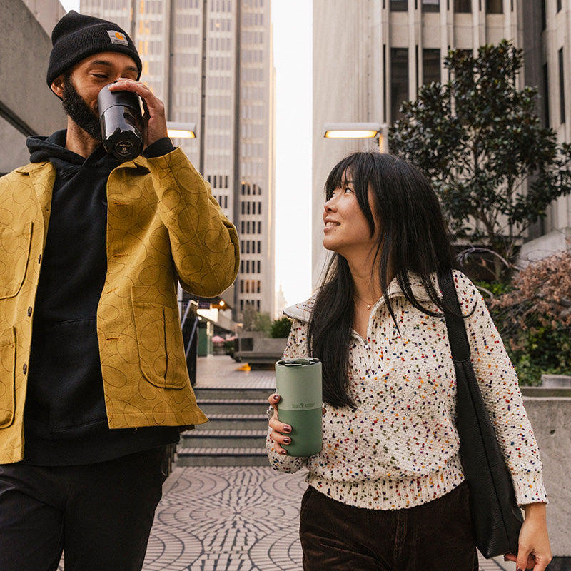 16oz-rise-tumbler-l4 16oz_rise_tumbler_black_iceberg_couple_drink_city_street_square.jpg