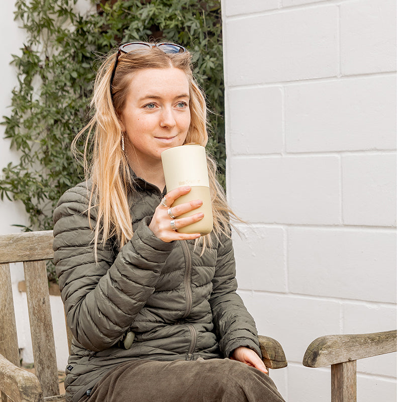16oz-rise-tumbler-l4 16oz_rise_tumbler_wax_yellow_woman_seat_outside_square.jpg