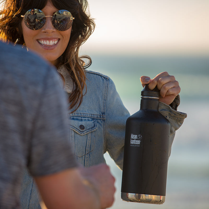 64oz-classic-with-loop-cap-b9 64oz_insulated_classic_black_beach_girl_hand_square.jpg